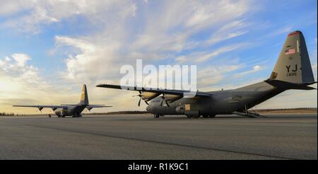 Due Stati Uniti Air Force C-130 Hercules preparare a prendere il via dal Fort Greely, Alaska, linea di volo, il 9 ottobre 2018, durante la bandiera rossa-Alaska 19-1. Durante la missione il M142 ad alta mobilità razzo di artiglieria sistema caricato fuori dall'aereo, percorsa da un punto di cottura e viaggiato indietro all'aeromobile in meno di un'ora. Foto Stock