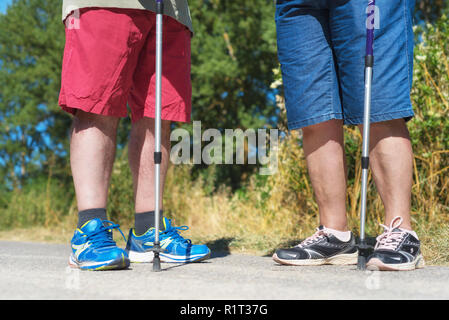 Escursionista senior per le gambe e i bastoni per escursioni vicino fino Foto Stock