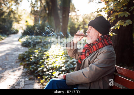 Piacevole uomo senior godendo il suo sigaro cubano Foto Stock