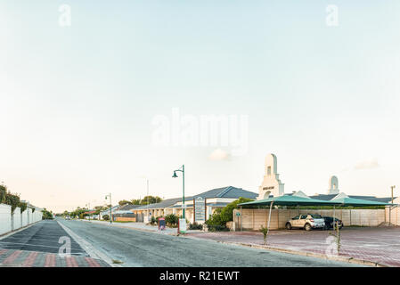 LANGEBAAN, SUD AFRICA, 20 agosto 2018: un tramonto scena di strada, con il centro Queens-Cottage, case e veicoli, in Langebaan nel Western Cape Foto Stock