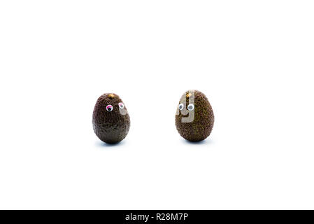 Romantico avocadi giovane con googly occhi come uomo e donna, funny food concept per progetti creativi. Foto Stock