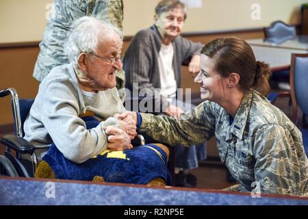 1Lt. Ashley Chapa, direttore della pari opportunità ufficio, assegnato al centottantesimo Fighter Wing, parla con gli Stati Uniti Esercito la II Guerra Mondiale, veterano Rywalski romana, durante una cerimonia in onore di veterani in Swanton Healthcare & Centro di pensionamento in Swanton, Ohio, nov. 3. I membri con il 180FW Azienda funzionario di grado del consiglio locale ha visitato i veterani e li ha presentati con i certificati di onorare il loro servizio. Foto Stock