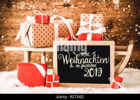 La slitta con doni, Calligrafia Glueckliches 2019 significa felice 2019, neve Foto Stock