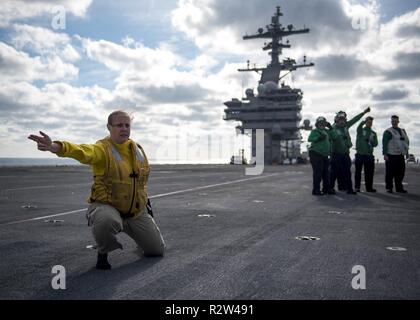 Oceano atlantico (nov. 10, 2018) Lt. La Cmdr. Betania Harrison, da Kansas City, Missouri, dà il segnale per lanciare i suoi stivali da la catapulta a bordo della portaerei USS George H.W. Bussola (CVN 77). Navy catapulta ufficiali tradizionalmente lanciare gli scarponi al termine di una tournée di successo. GHWB è in corso nell'Oceano Atlantico conduzione di routine di esercizi di allenamento per mantenere la disponibilità del gestore. Foto Stock