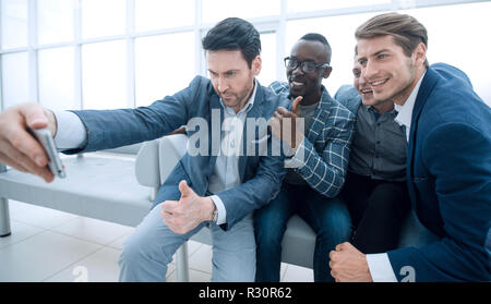 Team aziendale prende selfies nella lobby del centro business Foto Stock