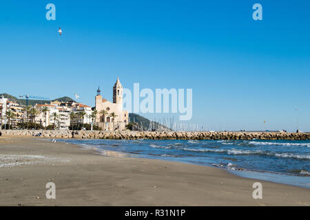 La bella città di Sitges con i gabbiani, inverno Spagna, paesaggio del litorale a Sitges, Parròquia de Sant Bartomeu mi Santa Tecla Foto Stock