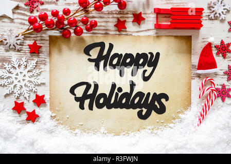 La carta con la calligrafia Inglese Buone Vacanze. Red decorazione di Natale come Sled, stelle, il simbolo del fiocco di neve e Santa Hat con neve. Foto Stock