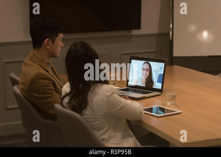 I dirigenti aziendali facendo una video conferenza su laptop Foto Stock