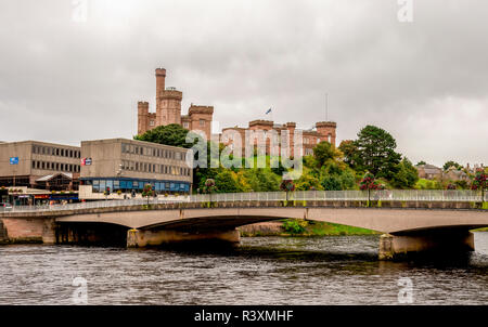 Ness bridge e una vista panoramica di rosso Inverness Castle su di una collina nel centro della città di Inverness, Scotland Foto Stock