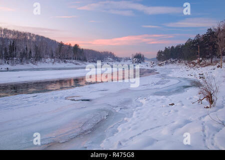 La riflessione del Cielo di tramonto in un fiume congelato. Fiume di Katun, montagne di Altai, Siberia, Russia Foto Stock