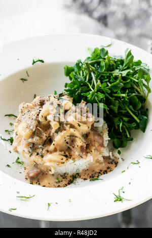 La carne di maiale Stroganoff con crema di funghi e la salsa di paprika pasto gourmet nel ristorante Foto Stock