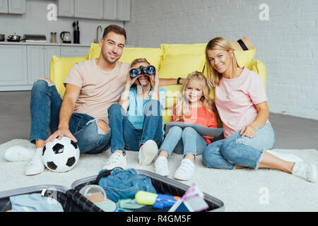 La famiglia felice spendendo molto tempo insieme durante l'imballaggio per le vacanze estive, il concetto di viaggio Foto Stock