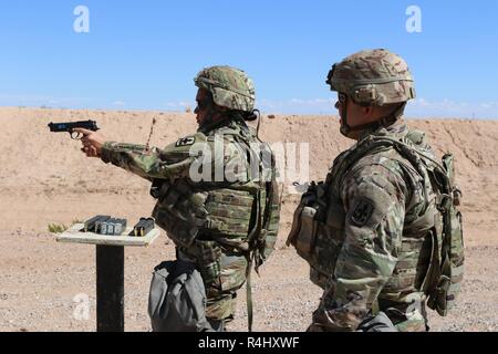 Spc. Janis K. Poole, una risorsa umana uno specialista con la XXIX brigata di fanteria combattere Team (IBCT) riceve il coaching dal 1 Sgt. Brandon Kumalae, della Sede Società (HHC), pur partecipando in M9 pistola la formazione in materia di sicurezza e di familiarizzazione su Ottobre 3, 2018 presso il Dona Ana gamma complessa, Nuovo Messico. Il corso di formazione prepara la ventinovesima IBCT soldati per distribuire al Kosovo nel sostegno delle multinazionali del Battle Group est le forze del Kosovo (KFOR). La KFOR è un a guida NATO di una forza internazionale per il mantenimento della pace, che è responsabile per la creazione di un ambiente sicuro in Kosovo. (Hawaii Esercito Nazionale G Foto Stock