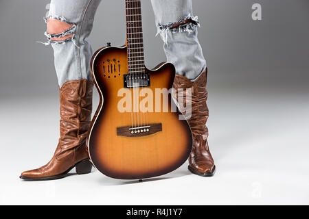 Gambe in jeans e stivali da cowboy Foto Stock