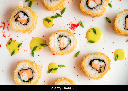 Rotoli di sushi sparsi su sfondo bianco Foto Stock