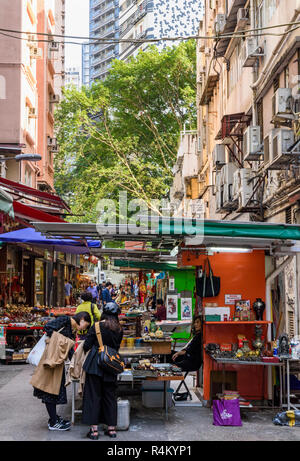 I turisti a fare shopping lungo superiore fila Lascar, comunemente noto come Cat St in Hong Kong Foto Stock