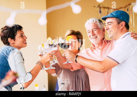 Happy amici divertendosi esterni - Giovani e anziani godendo il tempo del raccolto insieme - Concetto di amicizia - Mani tostatura di vino rosso e bianco vetro Foto Stock