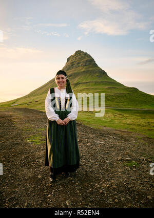 Una donna islandese locale che indossa l'Upphlutur tradizionale costume nazionale a Mt Kirkjufell a Grundarfjörður - Snæfellsnes Islanda Europa Foto Stock