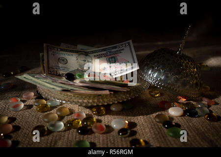 Dollari USA banconote in una ciotola di vetro con coperchio su un letto di sacco in modo decorativo. Il concetto di business