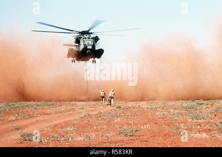 Un Marine elicottero pesante Squadron 363 (HMH-363) CH-53D Sea Stallion elicottero offre un carico di grano per un campo al di fuori del villaggio di Maleel durante la multinazionale soccorsi RESTORE HOPE. La granella, donati da Australia, è volato in invece di motivati perché si sospetta che le strade carico al villaggio sono state minate. Foto Stock