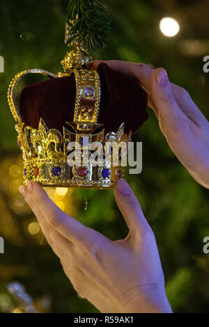 Windsor, Regno Unito. 30 Novembre, 2018. Gli Appartamenti di Stato al Castello di Windsor sono state decorate con scintillanti alberi di Natale e scintillanti luci di Natale. Visto qui in St George's Hall una corona ninnolo appeso su un sorprendente 20ft Nordmann abete dal Windsor Great Park vestito d'oro. Un 15ft albero di Natale viene visualizzato anche nell'Crimson Drawing Room. Foto Stock