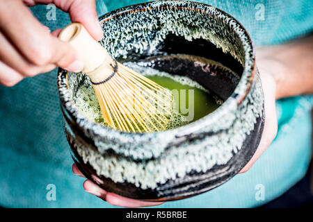 Donna preparazione matcha, polvere di tè verdi giapponesi Foto Stock