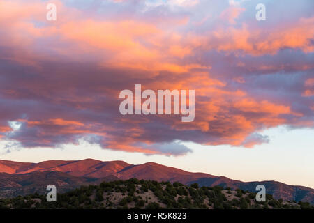 Drammatico, bel tramonto proietta viola e arancione i colori sulle nuvole e montagne del Sangre de Cristo vicino a Santa Fe, New Mexico Foto Stock