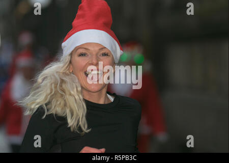 Donna felice a Santa Hat a Liverpool, Merseyside, Regno Unito. 2nd Novembre 2018. BTR Liverpool, Santa Dash. Le persone di Merseyside festeggiano il ritorno della più grande corsa festiva del Regno Unito per il divertimento 5K. L'evento festivo ha continuato a crescere con la partecipazione di un massimo di 10.000 secondi classificati, rossi e blu Santas, quest'anno. Il percorso ha portato le tratteggiate Santas attraverso il centro della città, prima di attraversare il traguardo fuori dal Municipio, dove sono stati accolti da una miriade di personaggi festosi. Foto Stock