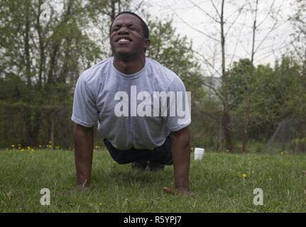 Stati Uniti Air Force Airman 1. Classe Franklin Harris, un videografo di combattimento, assegnato al primo combattimento squadrone della fotocamera, esegue il 150 push-up durante l'evento Hilda sfida nel 2017 quinto annuale SPC Hilda I. Clayton meglio combattere la telecamera (COMCAM) Concorrenza a Fort George G. Meade, Md., 17 aprile 2017. Harris è competere nel 2017 quinto annuale migliore concorrenza COMCAM dove squadre di due competere per tutta la durata di un evento di giro che le prove del loro stato fisico e mentale e di capacità tecniche. La concorrenza è stabilita in onore di combattimento caduti soldato fotocamera SPC Hilda I. Clayton, che diede la sua vita Foto Stock