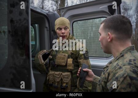 Stati Uniti Marine Corps Sgt. John Watson, un poliziotto militare con Marine forza rotazionale Europa 17.1 (MRF-E), riceve HK MP5 riviste da un Norvegese Home Guard 12 soldato durante una stanza di compensazione di esercizio a Vaernes guarnigione, 26 aprile 2017. Marines svolto attività di formazione per mantenere la loro prontezza e condividere la loro stanza-clearing tattiche con Home Guard 12. MRF-E si basa sul partenariato negli Stati Uniti con la Norvegia attraverso la condivisione di valori e di esperienze. Foto Stock