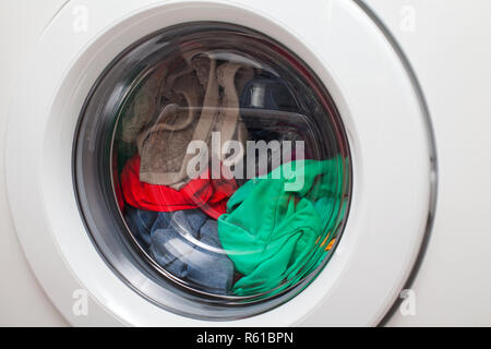 Moderna macchina lavatrice automatica caricato con abiti colorati Foto Stock