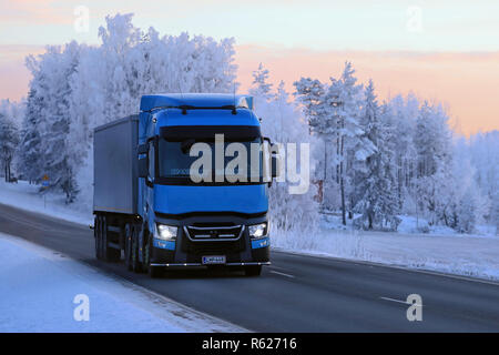 Salo, Finlandia - 19 Gennaio 2018: Blu Renault Trucks T semi di trasporto Sjoman Oy Ab tira il rimorchio su autostrada rurale attraverso il paesaggio invernale al tramonto. Foto Stock