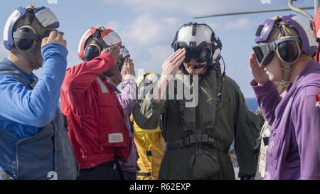 Mare delle Filippine (nov. 17, 2018) posteriori Adm. Karl O. Thomas, commander, battle force settima flotta, saluta come egli passa attraverso il lato i ragazzi sul Ticonderoga-class guidato-missili cruiser USS Chancellorsville (CG 62) durante una visita programmata. Chancellorsville è distribuita negli Stati Uniti 7 flotta area di operazioni a sostegno della sicurezza e della stabilità nella regione Indo-Pacifico. Foto Stock