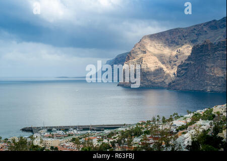 Los Gigantes rocks in raggi di sole. Cielo drammatico e calma oceano. Foto Stock