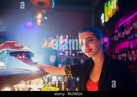 Immagine ritagliata lavoratore di sesso femminile che accettare un pagamento da parte del cliente tramite NFC in bar Foto Stock