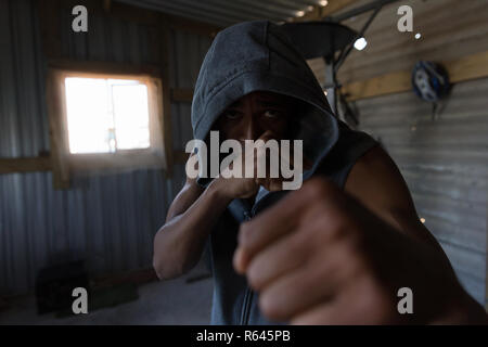 Boxer maschio di praticare il pugilato in studio fitness Foto Stock