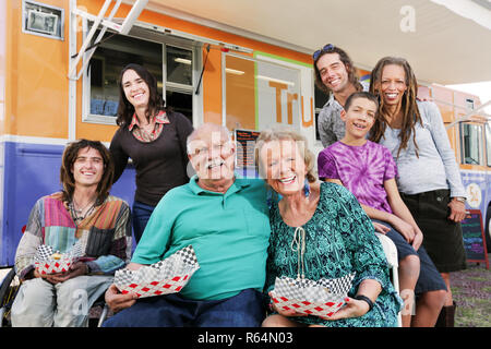 Coppia di anziani circondato da diversi amici Foto Stock