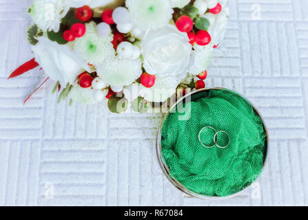 Matrimonio gli anelli di fidanzamento con fiori Foto Stock