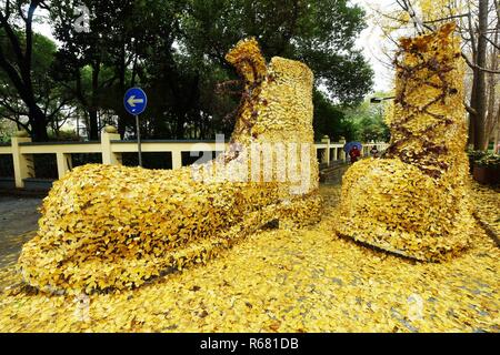 Hangzhou, Hangzhou, Cina. 4° dic, 2018. Hangzhou, Cina-una coppia di gigante " stivali'made di golden foglie di ginkgo può essere visto sulla strada di Hangzhou, Cina. Credito: SIPA Asia/ZUMA filo/Alamy Live News Foto Stock