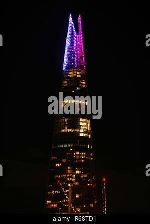 Luci festose di illuminare la parte superiore a venti piani dell'edificio di Shard a Londra come parte di una mezza ora di mostrare che correrà per tutta la sera durante il periodo natalizio. Foto Stock