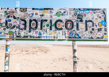 Cartello stradale con molti adesivi indicanti il Tropico del Capricorno in C-14 road, Namibia Foto Stock