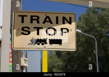 Cartello stradale con la scritta in inglese 'arresto del treno" e il simbolo della locomotiva nero Foto Stock