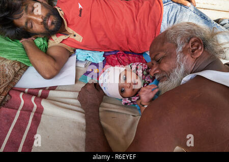 I membri di una famiglia di cosiddetti marciapiede abitatori di Mumbai, India, senzatetto dormire in strada, con i loro 5 mesi più tardi gli stati (la ragazza) Foto Stock