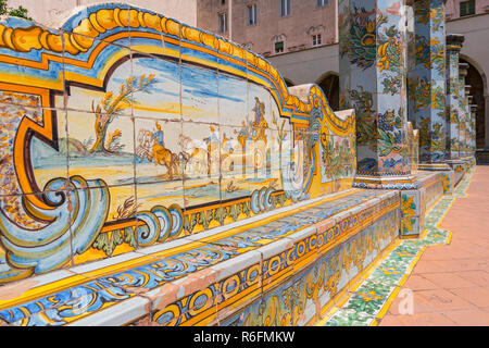 Sunny chiostro delle Clarisse decorate con piastrelle di maiolica dal monastero di Santa Chiara a Napoli, Italia Foto Stock