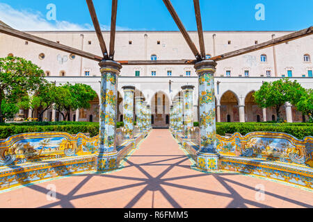 Sunny chiostro delle Clarisse decorate con piastrelle di maiolica dal monastero di Santa Chiara a Napoli, Italia Foto Stock