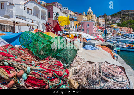 Grazioso Villaggio di Pescatori, colorate case di pescatori e reti da pesca, Marina Corricella Isola di Procida e della baia di Napoli, Italia Foto Stock