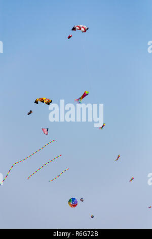 Aquiloni colorati volare nel cielo contro un cielo blu Foto Stock