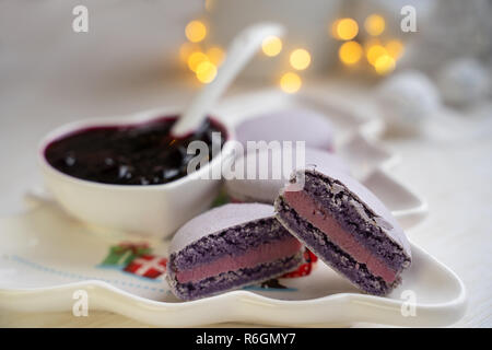 Amaretti con uve secche di Corinto su una piastra bianca con marmellata Foto Stock