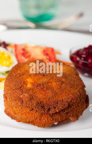 Camembert impanato con insalata su legno Foto Stock