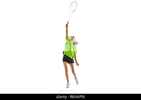 Il Caucaso in una giovane ragazza adolescente giocando badminton in studio. La femmina teen player isolati su sfondo bianco in movimento Foto Stock